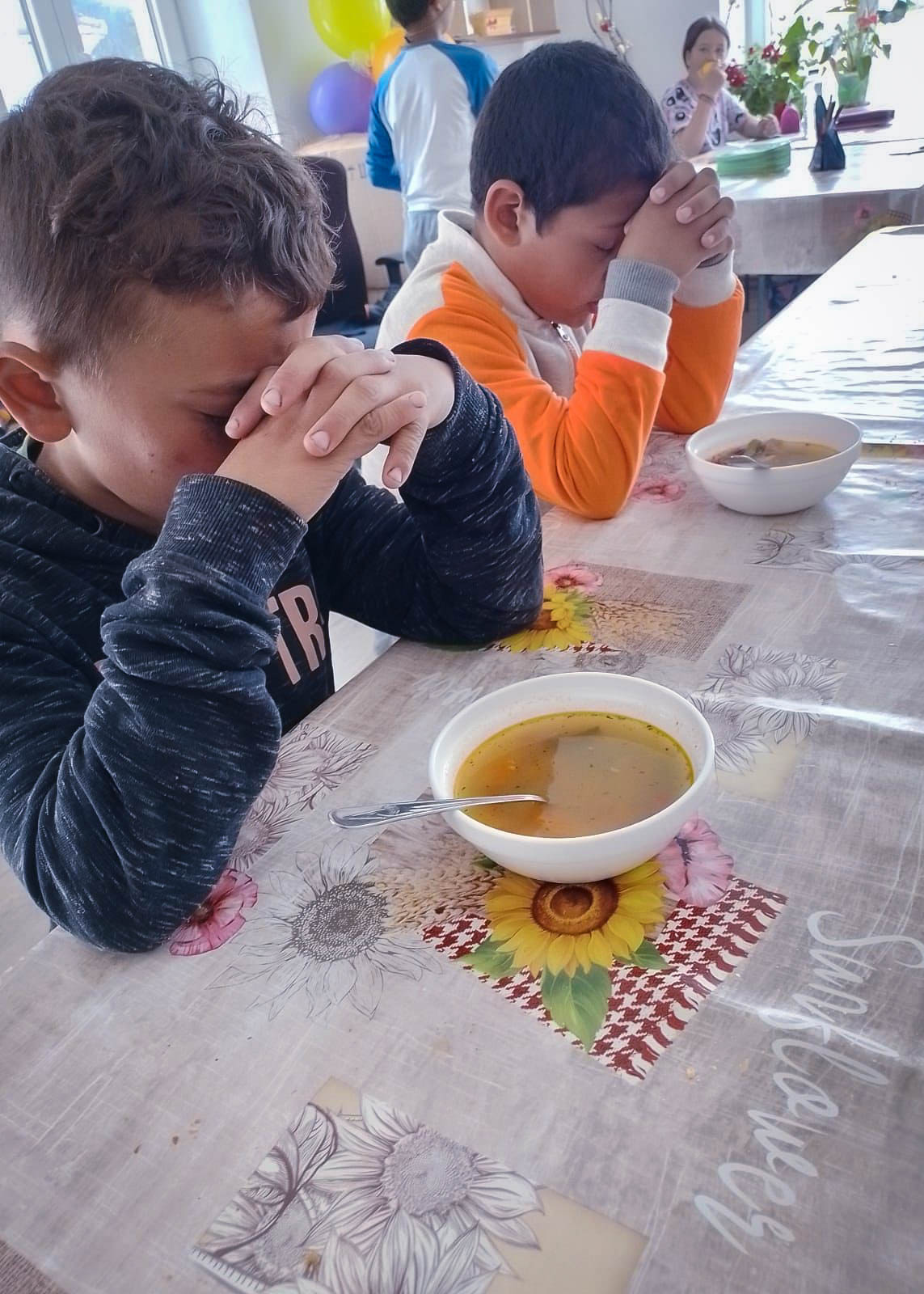 Roma children from Transylvanya praying before meal